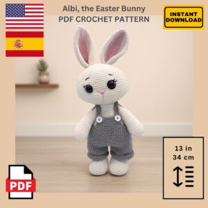 Crocheted bunny with pink-lined ears and gray overalls in a minimalist room. Label says "Albi, the Easter Bunny PDF Crochet Pattern." PDF and flags shown.